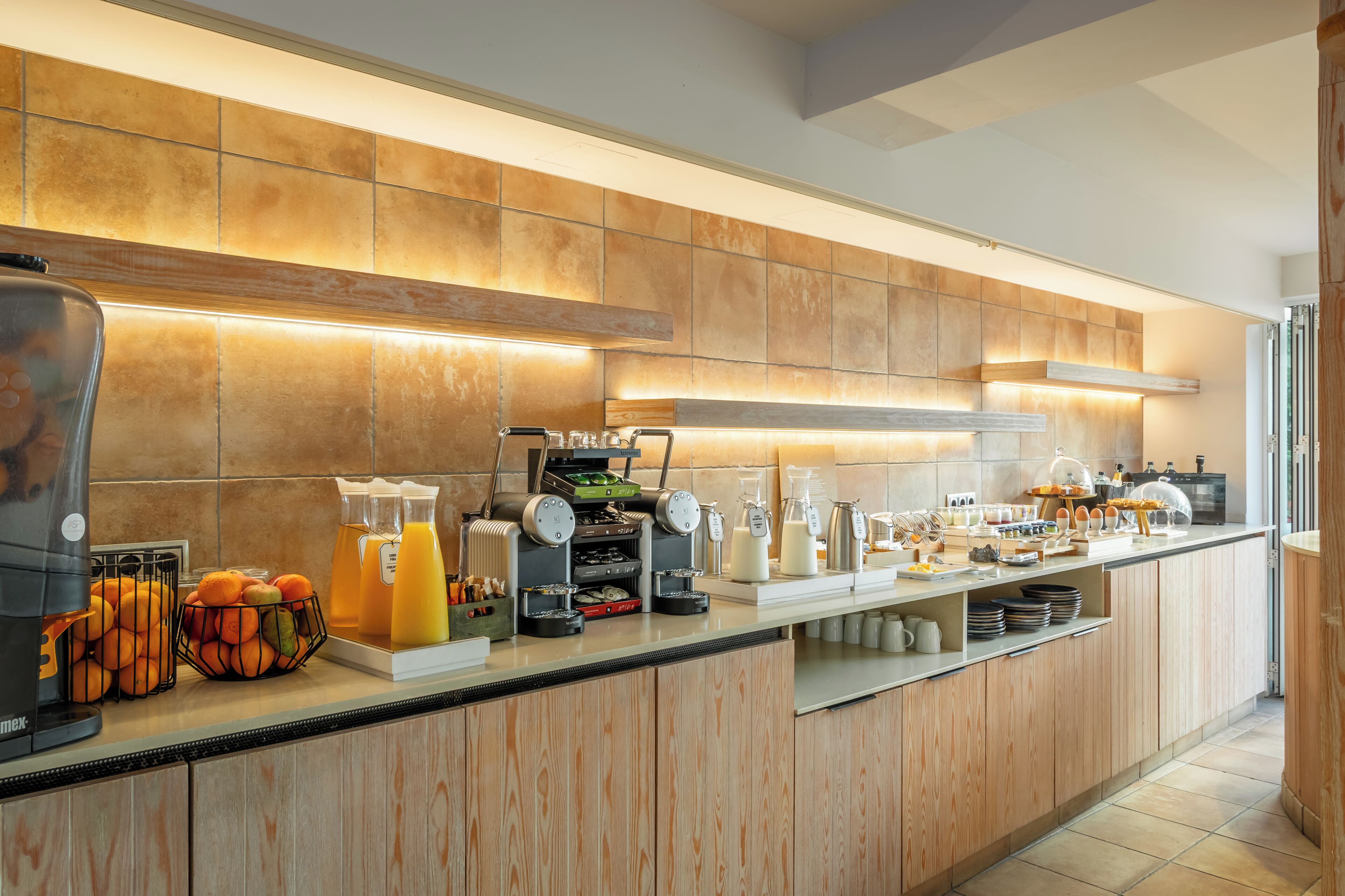 Cocina moderna con estación de café, frutero y diferentes electrodomésticos.