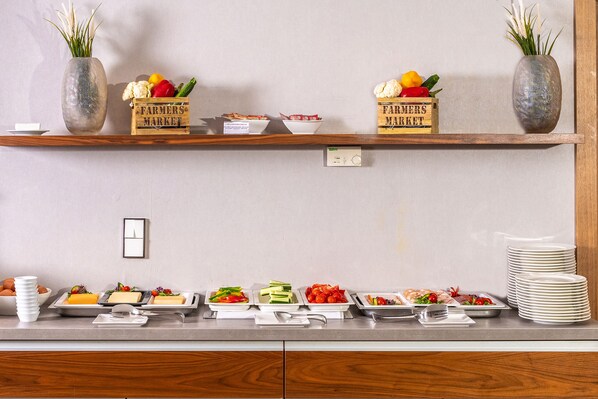 A buffet setup with various food items and decorative vases on shelves. - Charm Hotel Budapest (formerly Boutique Hotel Budapest) (Budapest)