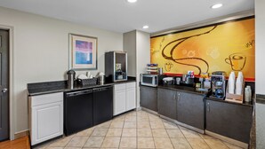 A modern kitchen with a microwave, coffee machine, and a coffee station. - Rodeway Inn (Temple)