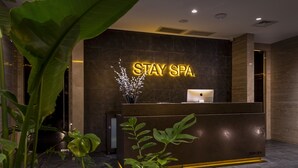 A reception desk with a 'STAY SPA' sign, a laptop, and a plant. - The Stay Boulevard Nisantasi (Istanbul)
