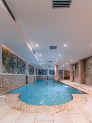 Indoor pool, open 9:00 AM to 9:00 PM, pool loungers