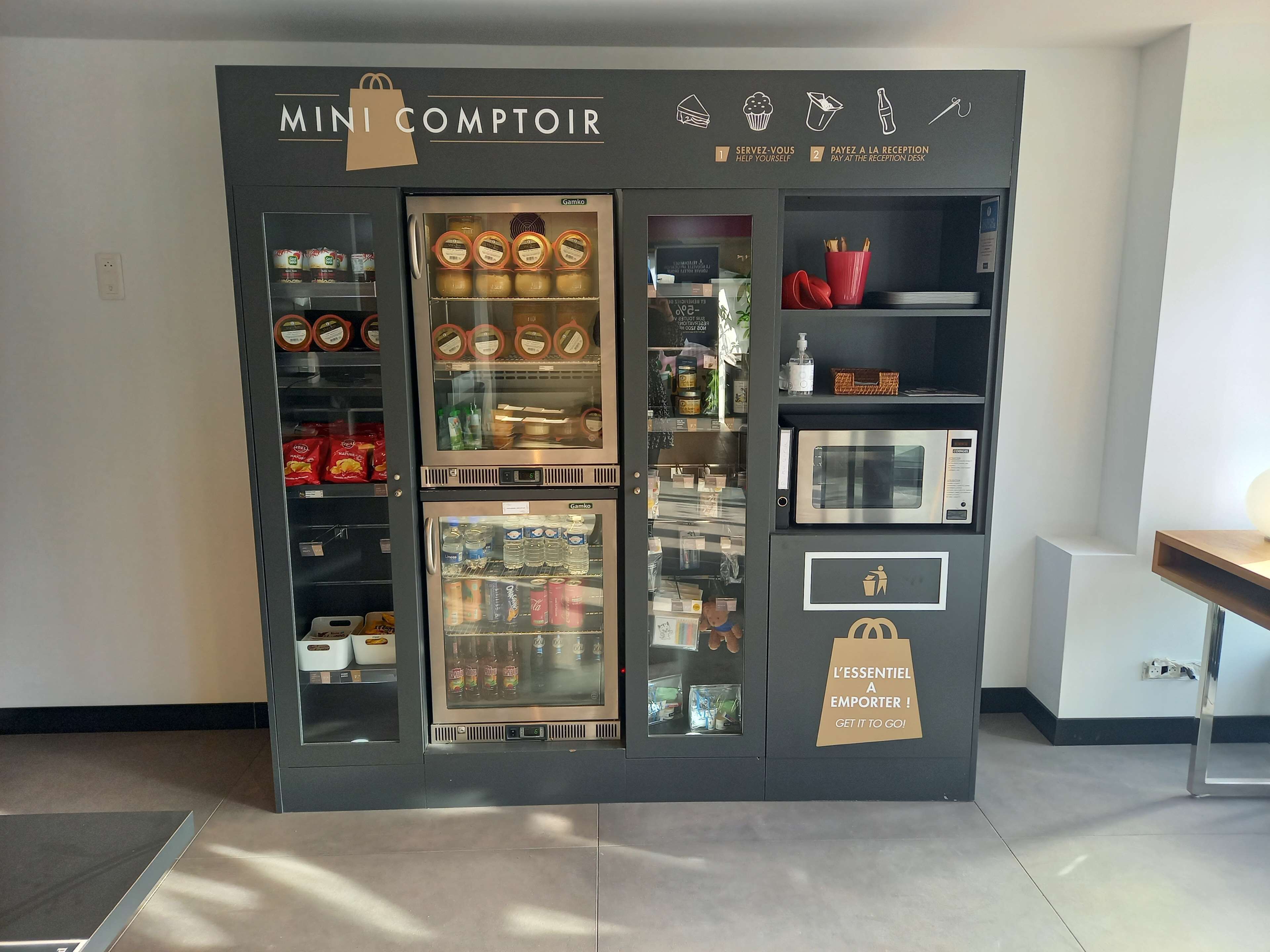 A self-service kiosk with a variety of food and drink options, including refrigerated sections and a microwave.