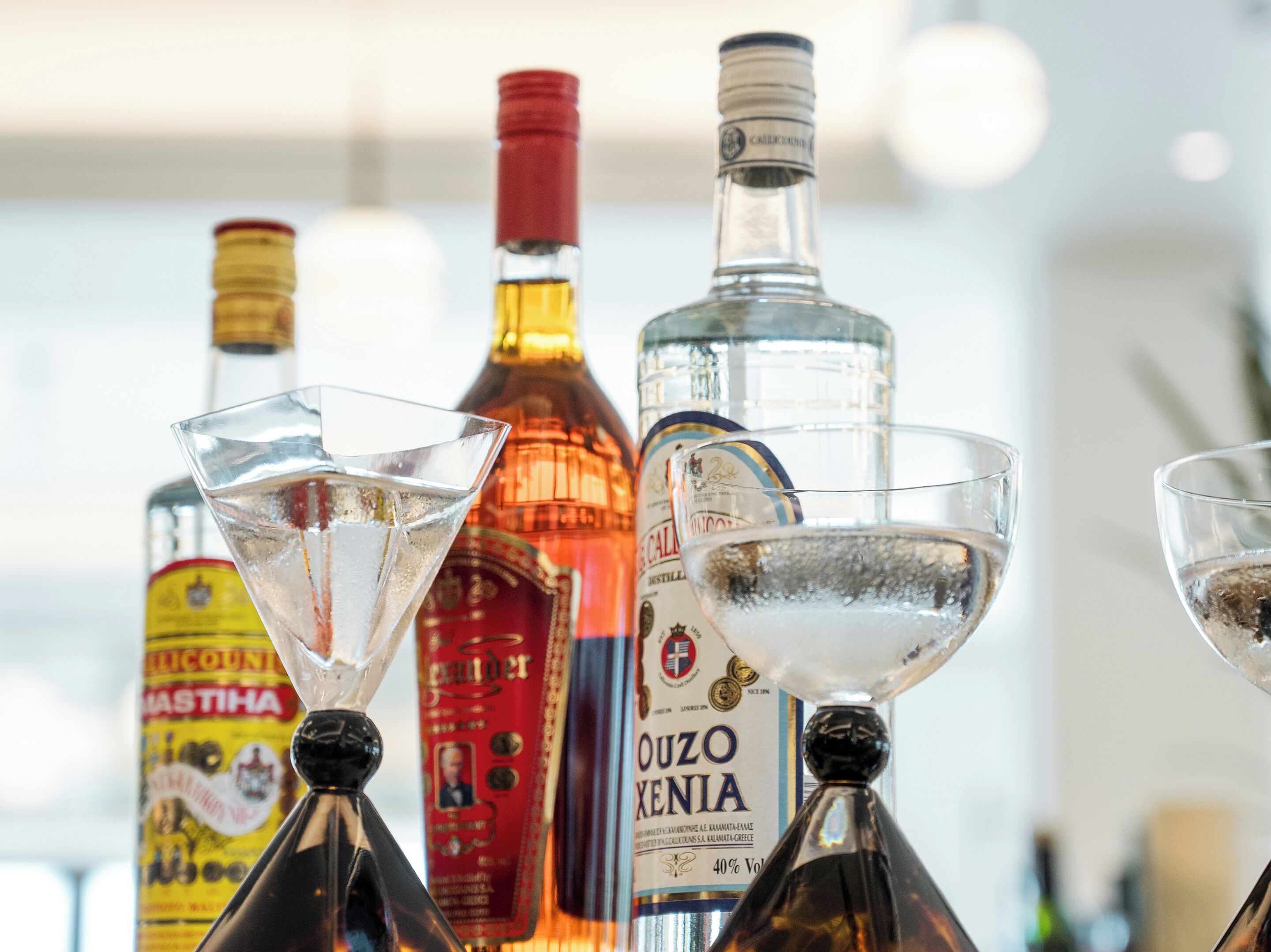 A collection of liquor bottles and martini glasses.