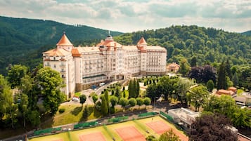 Experience the grandeur of this historic hotel, set amidst lush greenery on a hillside with breathtaking views of the surrounding forest.
