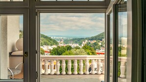 Un balcón con vistas a un paisaje urbano y vegetación.