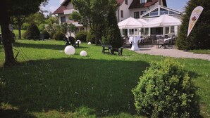 A well-maintained lawn with outdoor seating and a building in the background. - Hotel Empfinger Hof, Sure Hotel Collection by Best Western (Empfingen)