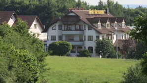 A large, two-story building with a balcony on the second floor, surrounded by greenery. - Hotel Empfinger Hof, Sure Hotel Collection by Best Western (Empfingen)