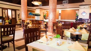 A restaurant with multiple tables and chairs, some with umbrellas. - Hulhule Island Hotel- Private Beach Access & Airport Pick-up and Drop (Hulhulé)