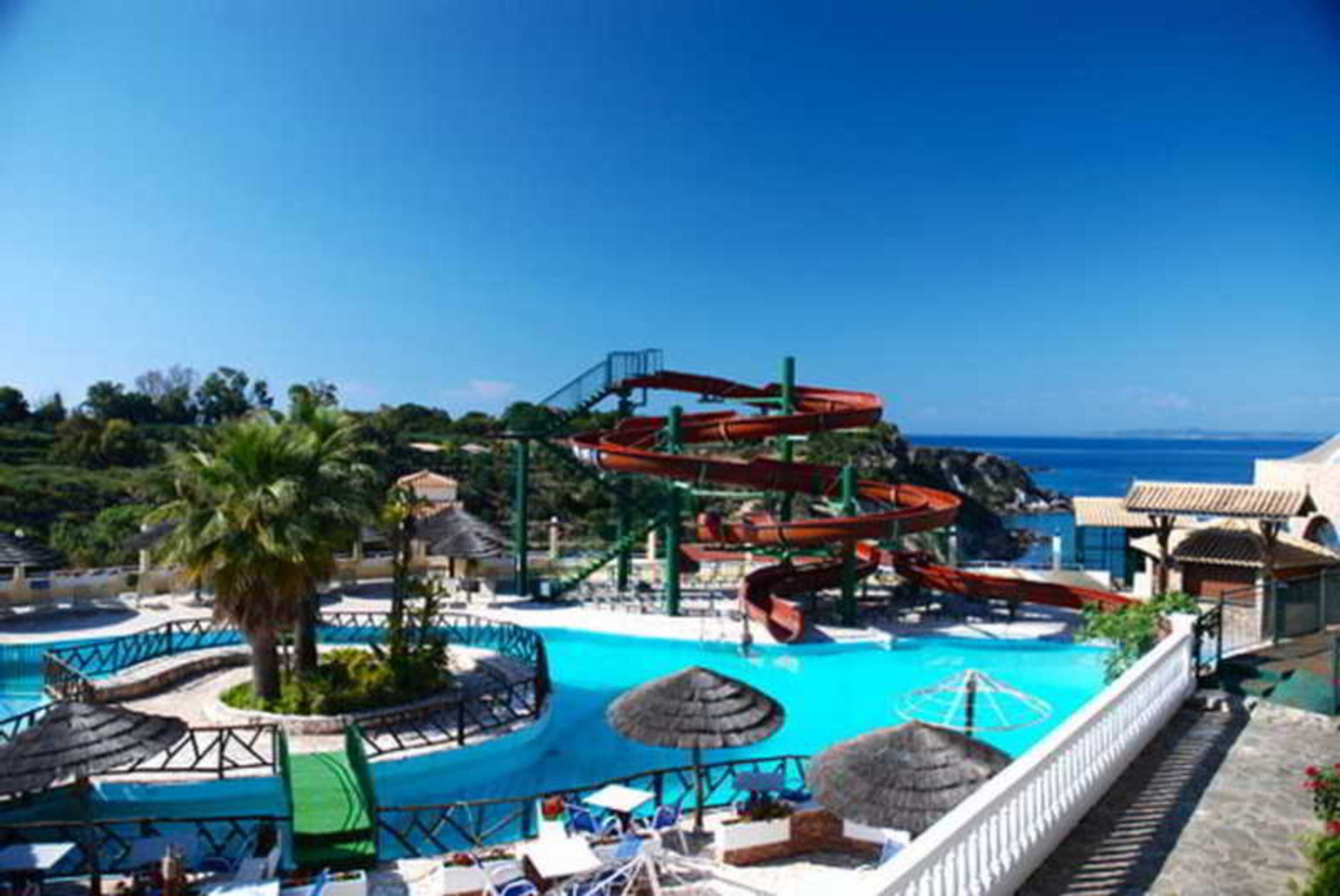 A water park with multiple slides and a pool area.