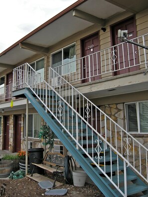 A two-story building with a blue staircase and white railings.