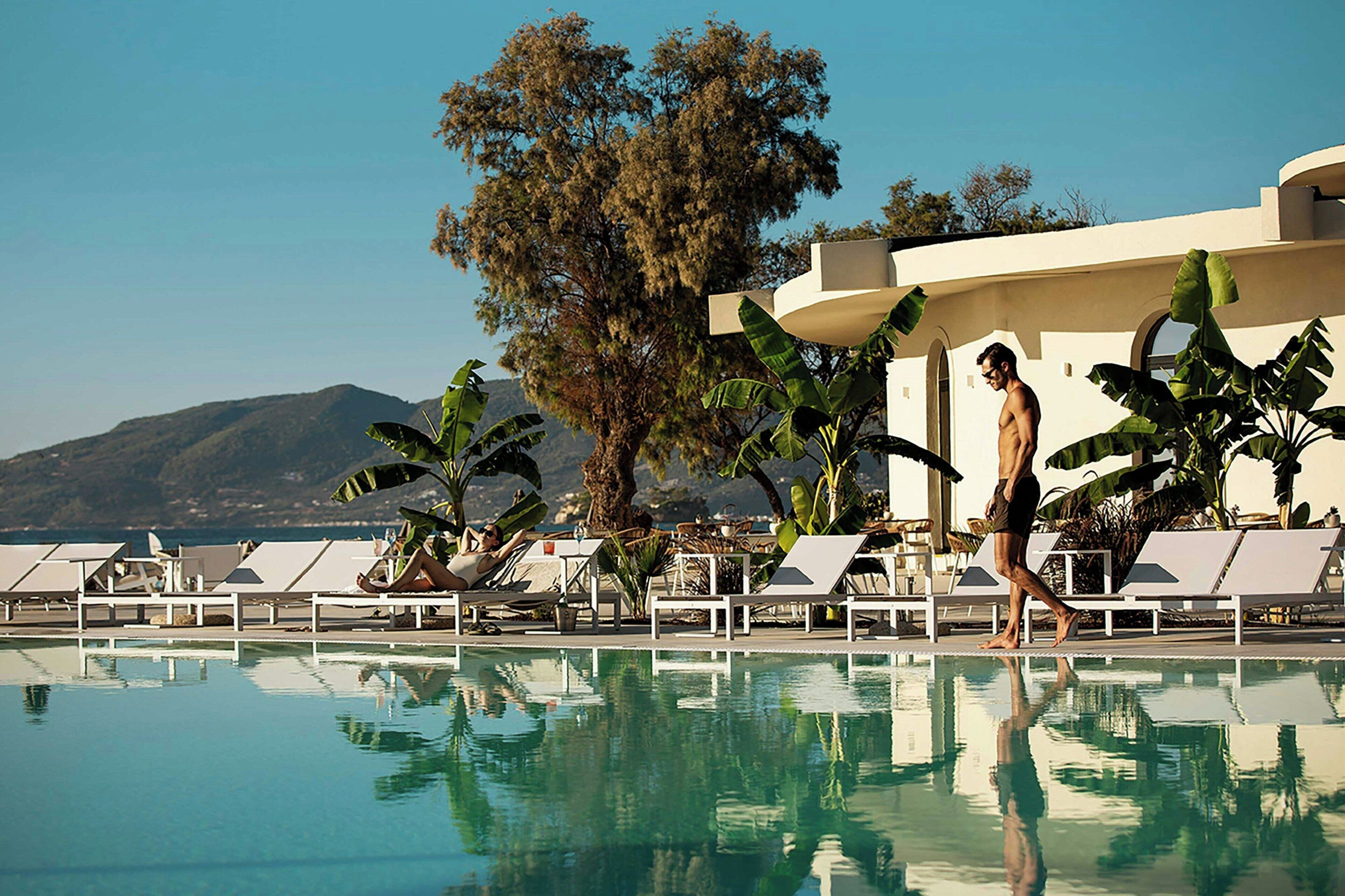 Alberca al aire libre, sombrillas en la alberca y camastros 