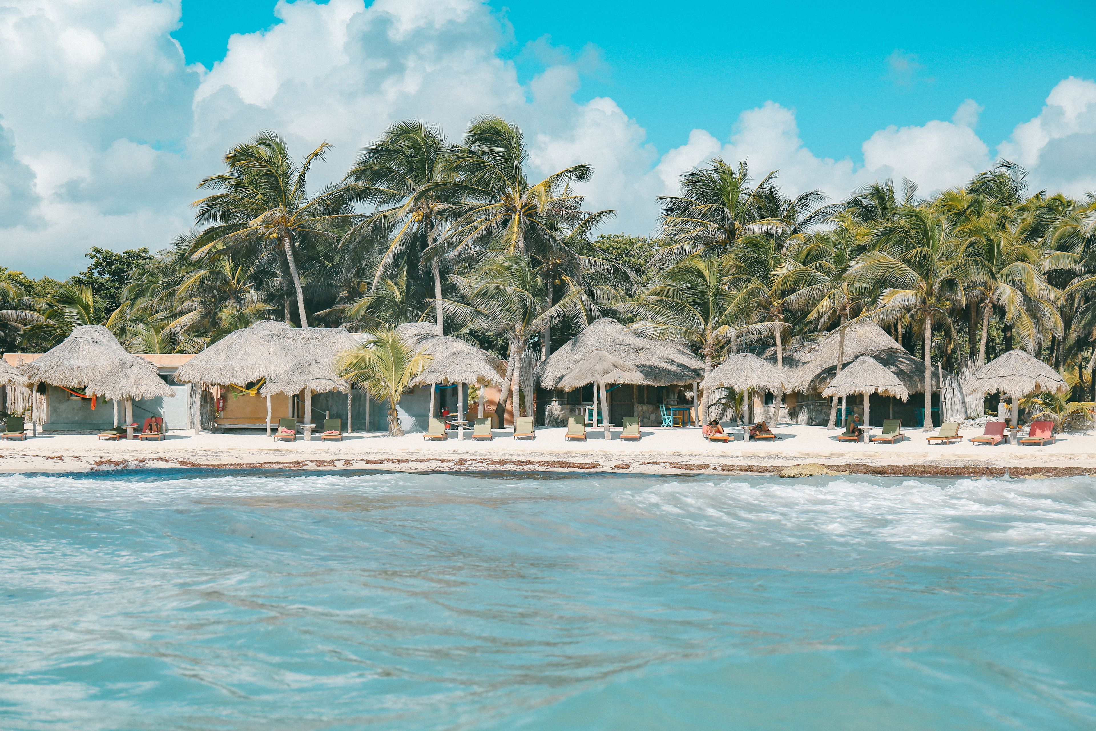 En la playa, playa de arena blanca, sombrillas y toallas de playa 