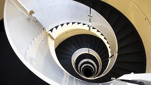 A spiral staircase with a metallic handrail and a black and white color scheme. - HOTEL SELENE POMEZIA (Pomezia)