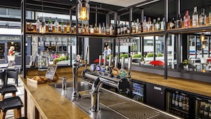 A bar area with multiple liquor bottles, a beer tap, and a coffee machine. - ibis Bristol Centre (Bristol)