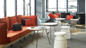 A modern lounge area with a sofa, chairs, and a coffee table. - ibis Bristol Centre (Bristol)