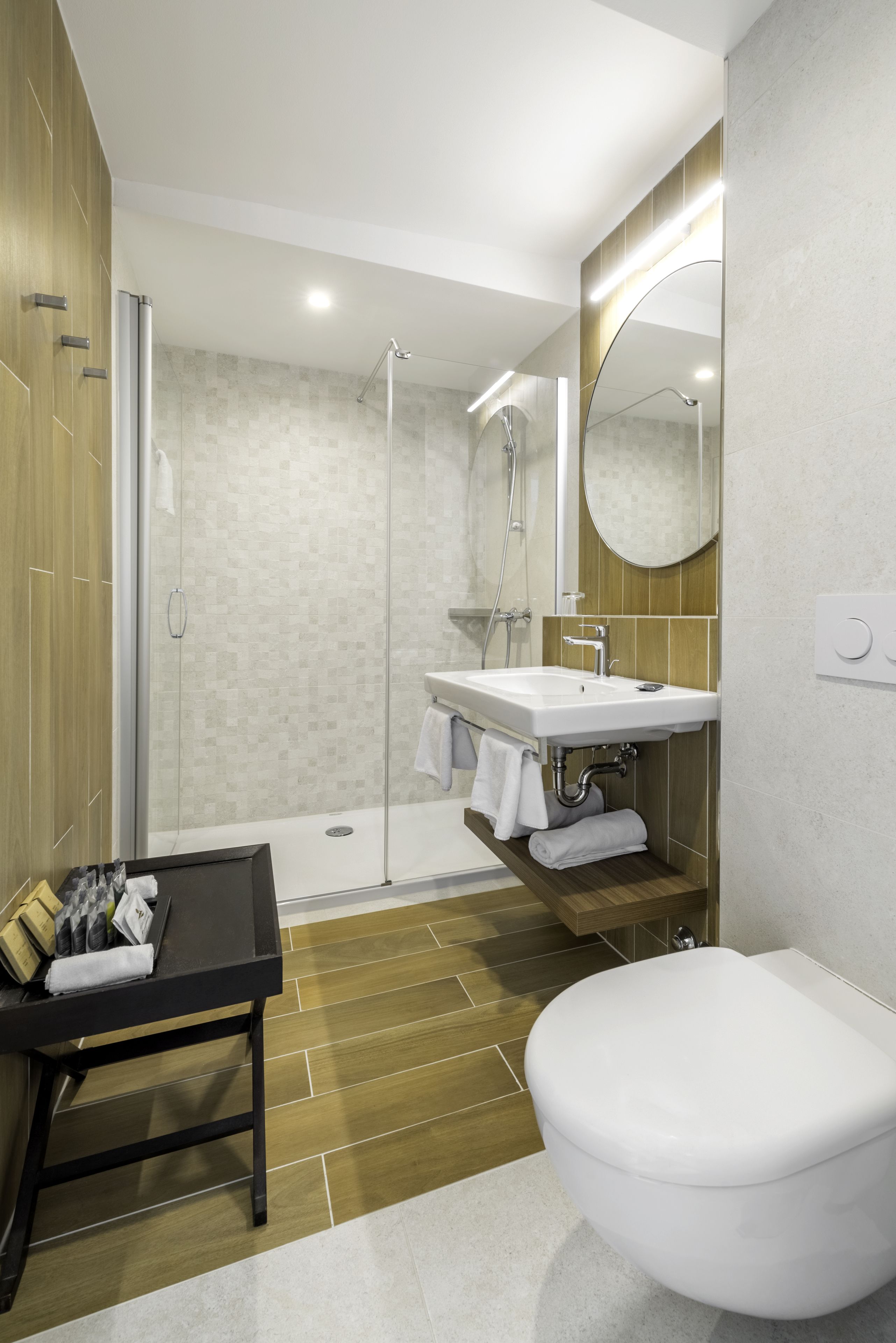 Une salle de bain moderne équipée d’une douche, de toilettes et d’un lavabo.