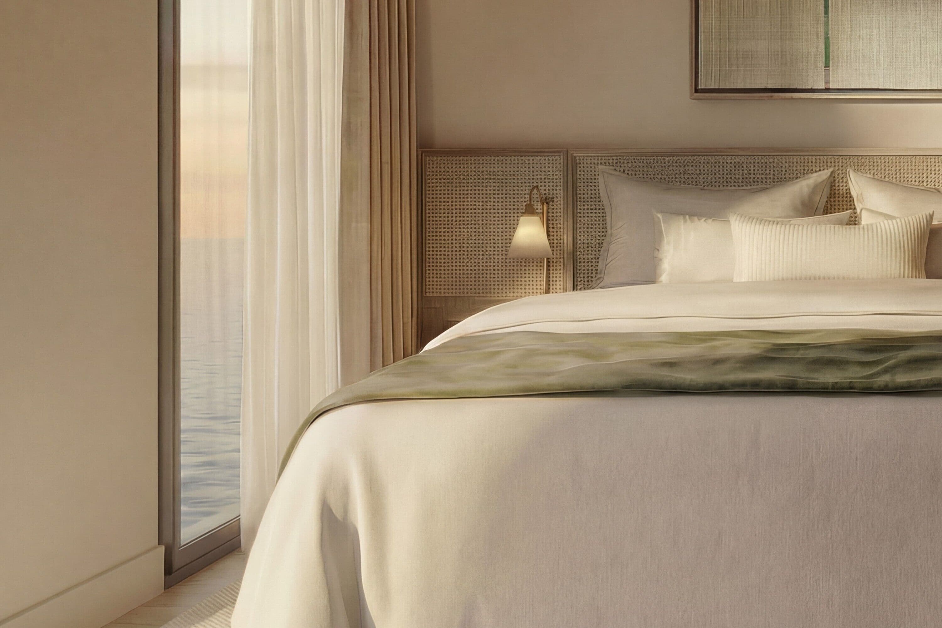 A modern hotel room with a large bed, a view of the city, and a large window with sheer curtains.