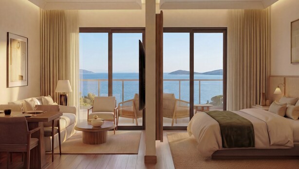 A hotel room with a large balcony, a bed, a sitting area with a table and chairs, and a view of the sea. - Sirena Resort Hvar - NEW IN 2026 (Hvar)