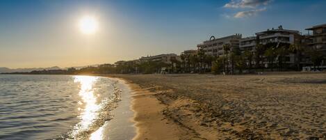 A beach with buildings in the background.