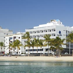 On the beach, white sand, sun loungers, beach umbrellas