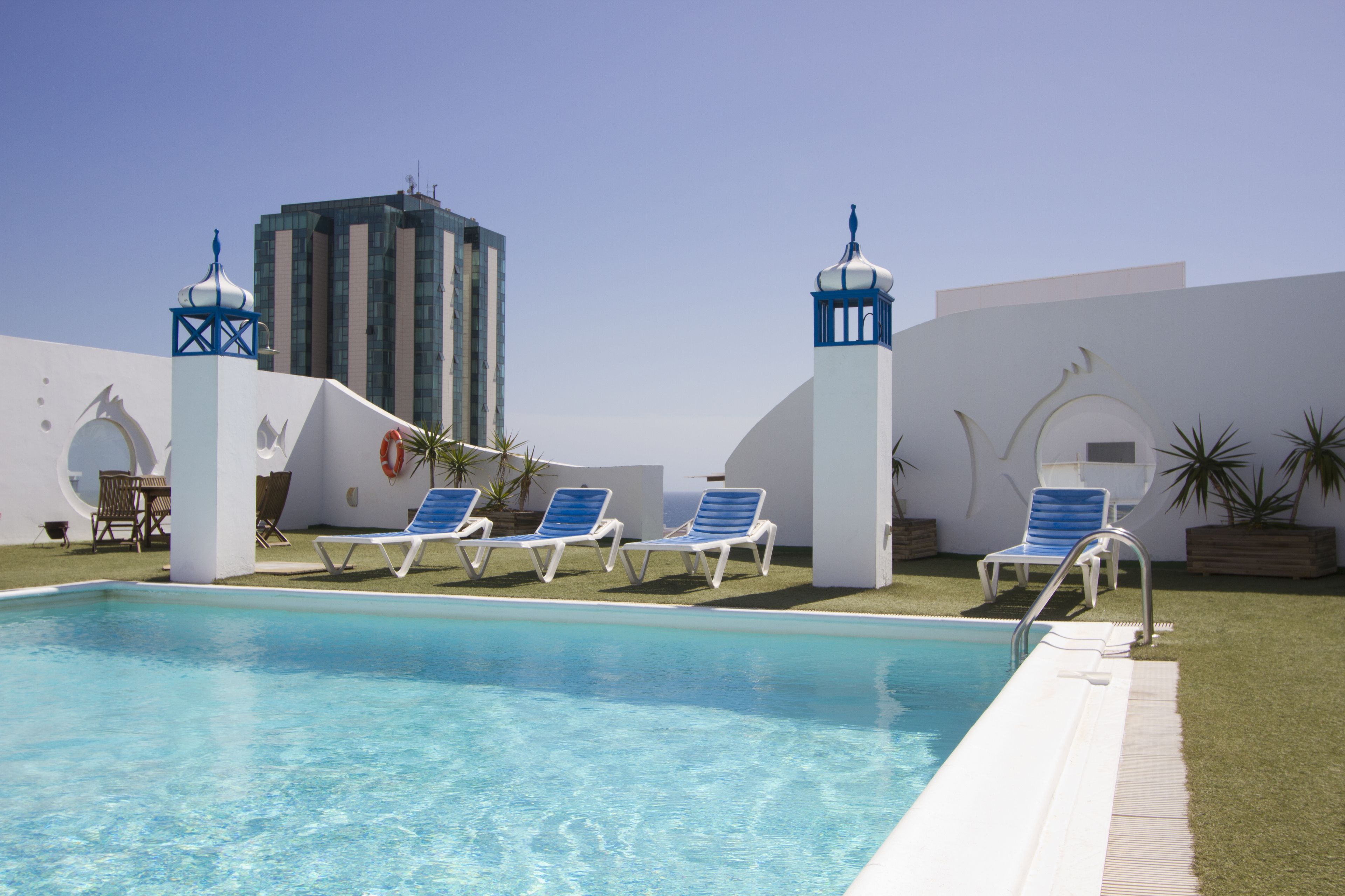 outdoor pool, open 9:00 am to 8:00 pm, pool umbrellas, pool loungers