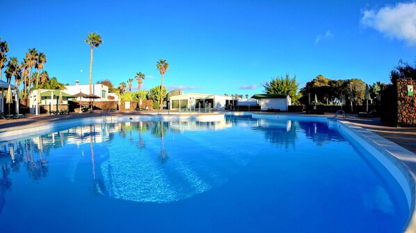 Outdoor pool, open 10:00 AM to 5:00 PM, pool umbrellas, sun loungers