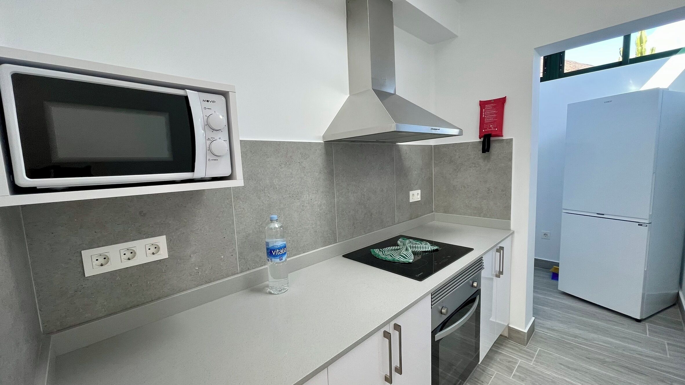 A modern kitchen with a built-in microwave, stove, oven, and a refrigerator.