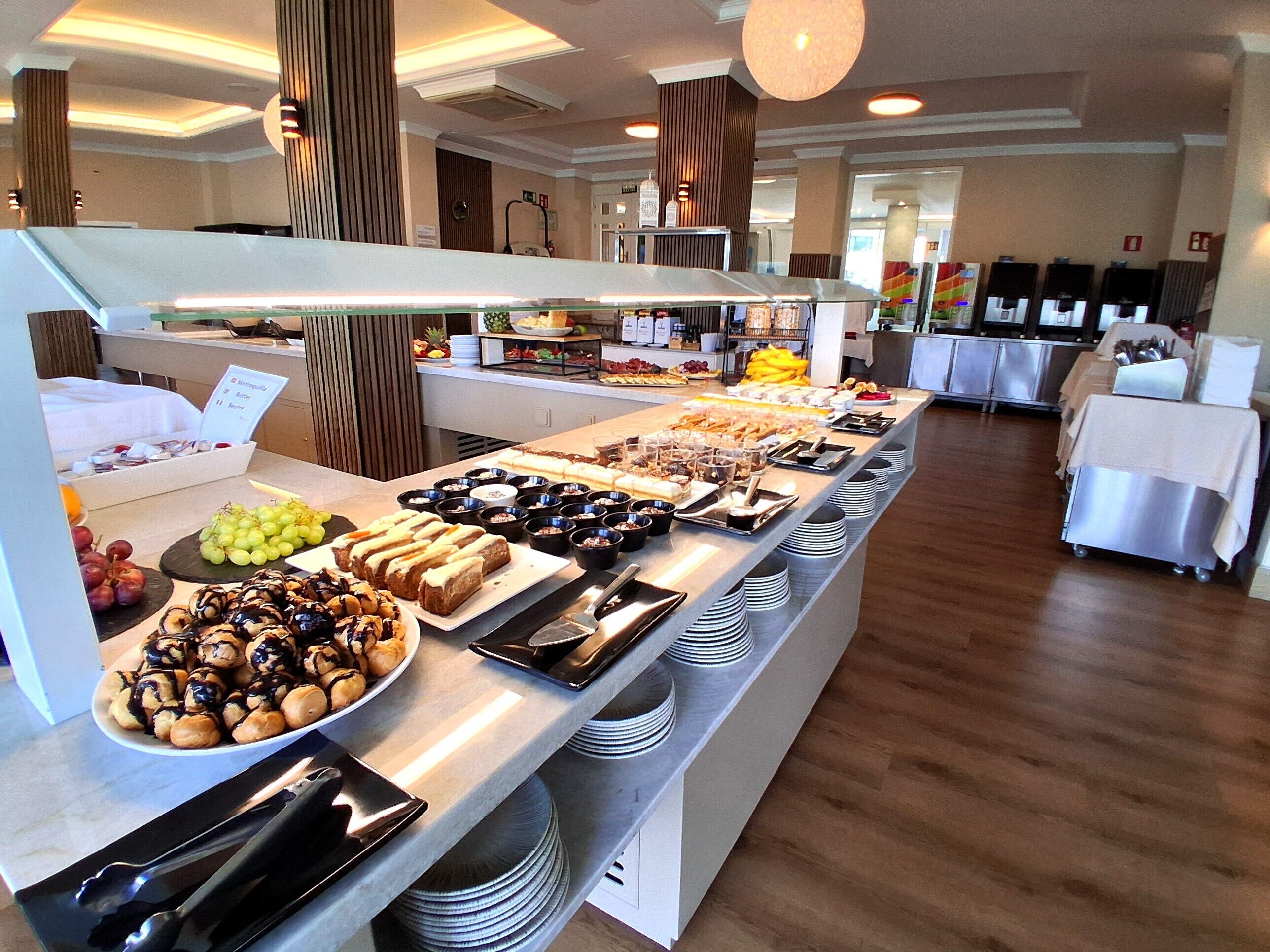 A buffet with various food items and utensils.