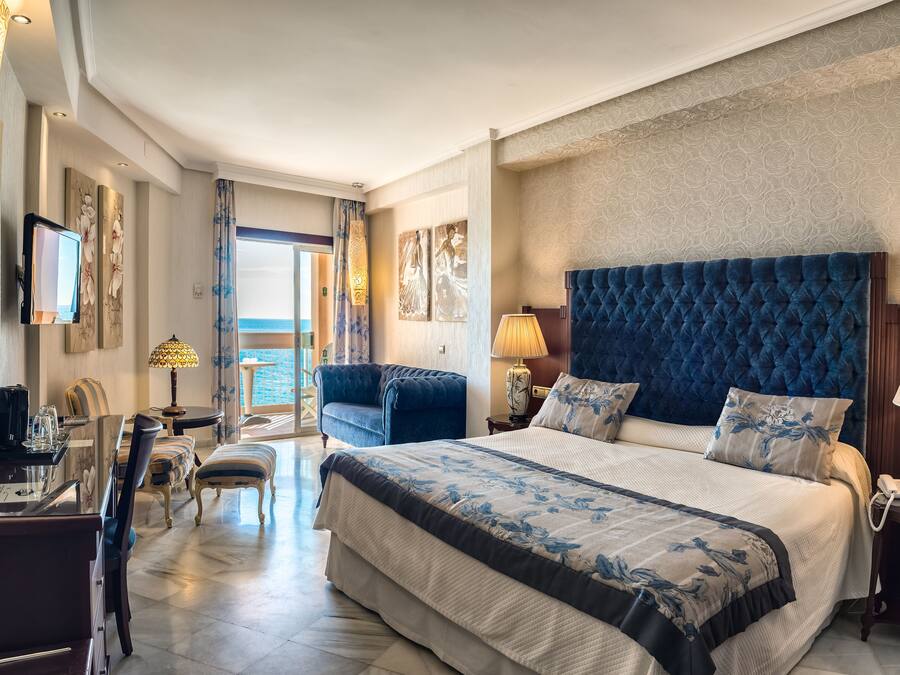 Junior Suite, Balcony, Sea View | Minibar, in-room safe, desk, laptop workspace