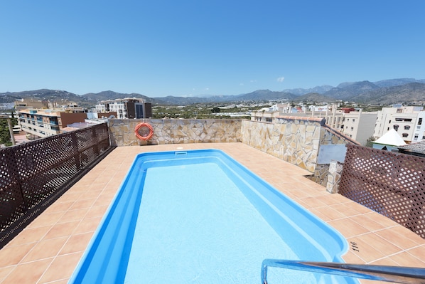 Seasonal outdoor pool, open 10:00 AM to 8:00 PM, pool umbrellas