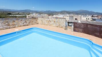 Seasonal outdoor pool, open 10:00 AM to 8:00 PM, pool umbrellas