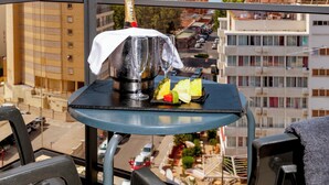A balcony with a table set for a drink, overlooking a cityscape with tall buildings. - Flash Hotel – Adults recommended (Benidorm)