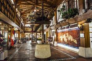 A historic building with wooden beams, a large stone centerpiece, and a map mural. - Hotel Tudanca Aranda II (Fuentespina)
