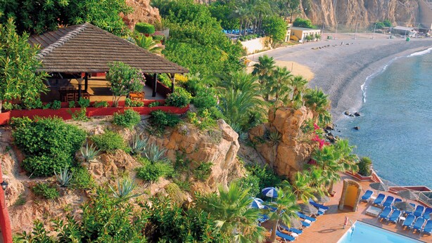 A beachside resort with a pool, lounge chairs, and a restaurant. - Mirador del Cabo Hotel Adults Recommended (Enix)