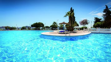 Una piscina al aire libre de temporada, sillones reclinables de piscina