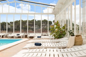 Indoor pool, open 9:30 AM to 7:30 PM, pool umbrellas, pool loungers