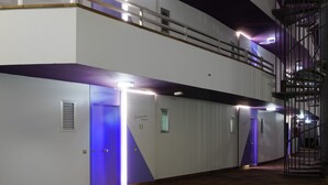 A modern hotel corridor with a double staircase, multiple doors, and a sign indicating 'Garrandas Beach'. - Jacarandas Beach (San Bartolomé de Tirajana)