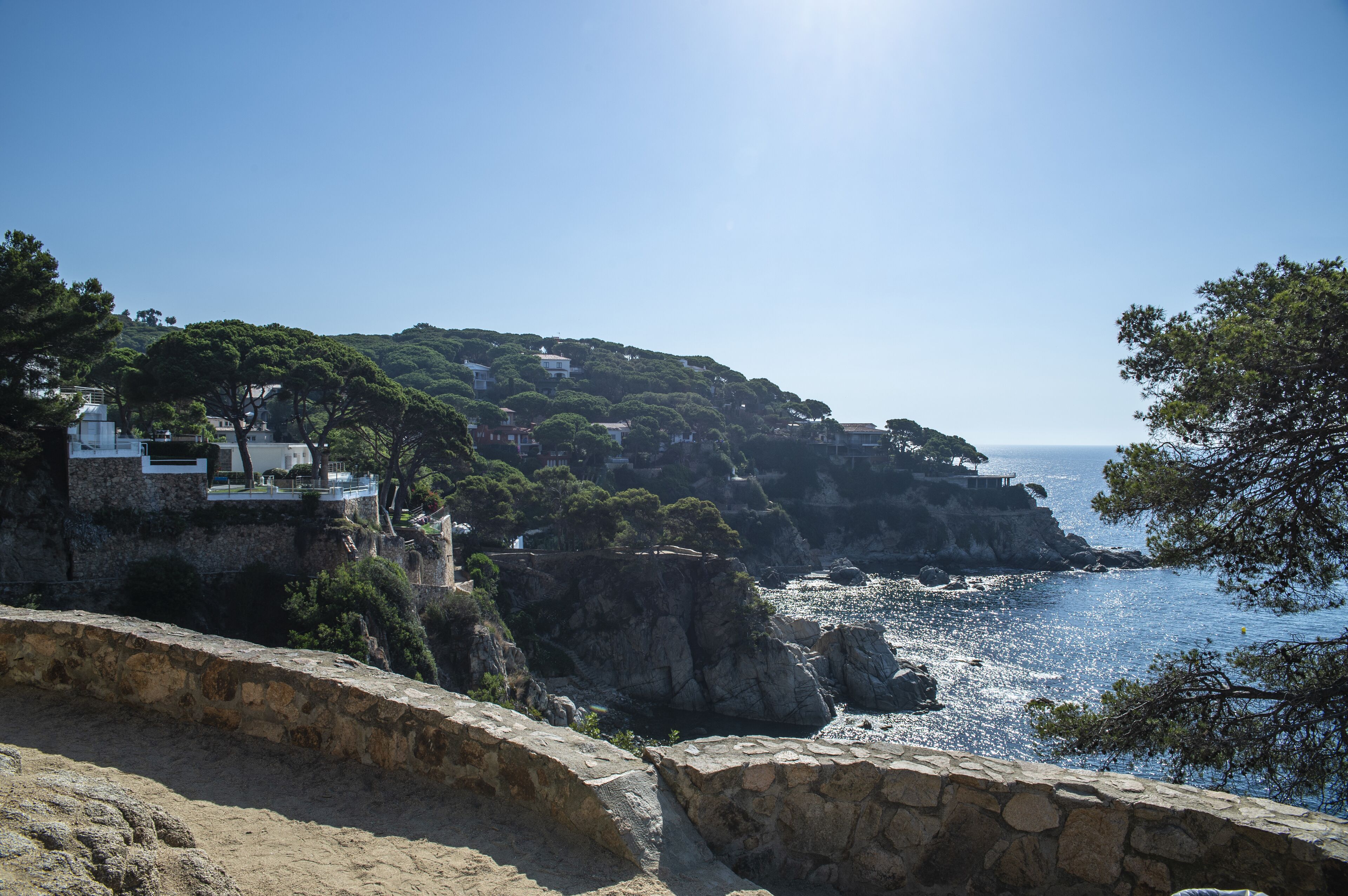 A coastal landscape with buildings on a cliff overlooking the sea.