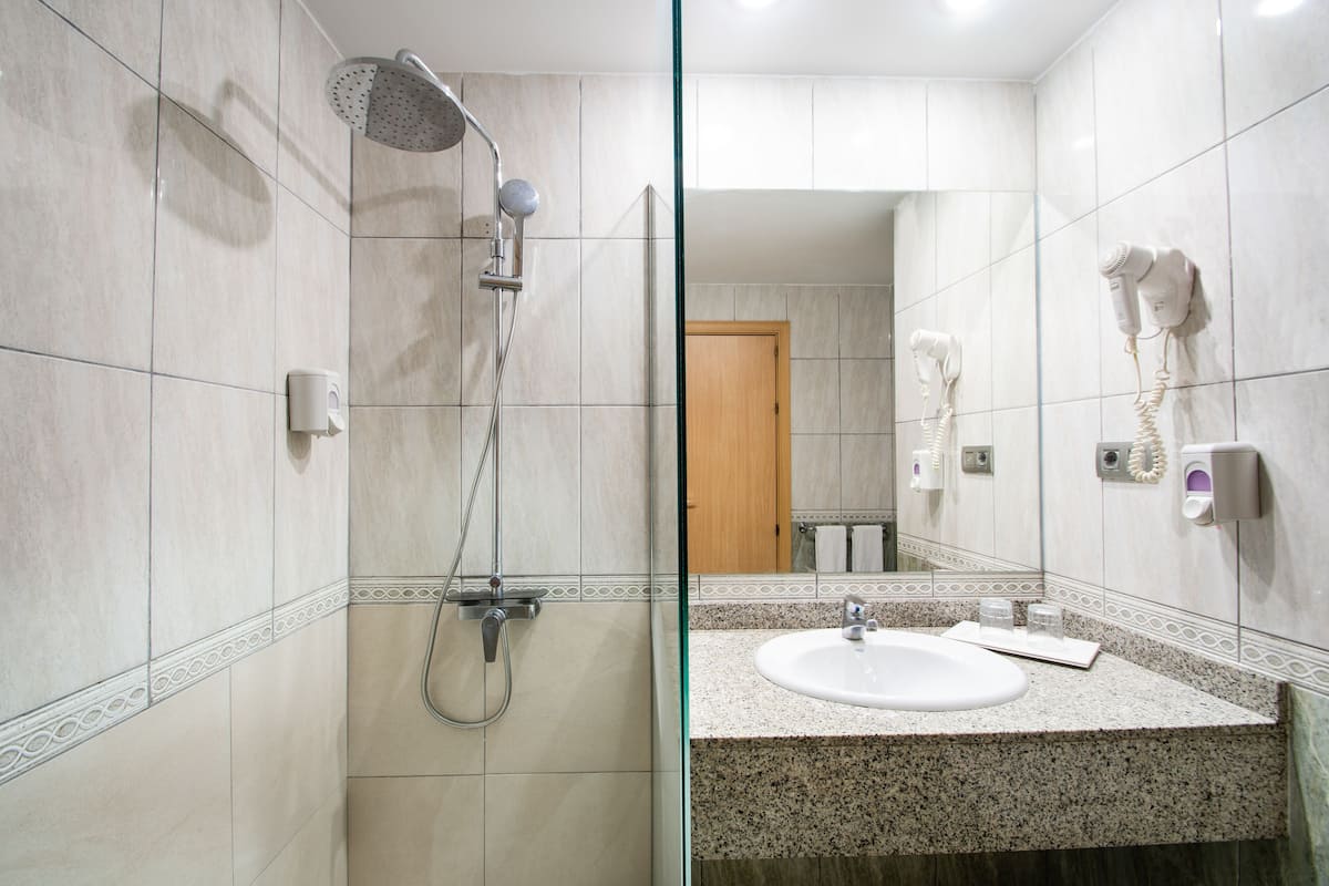 shower, rainfall showerhead, hair dryer, towels