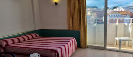 Escritorio, cortinas blackout y tabla de planchar con plancha