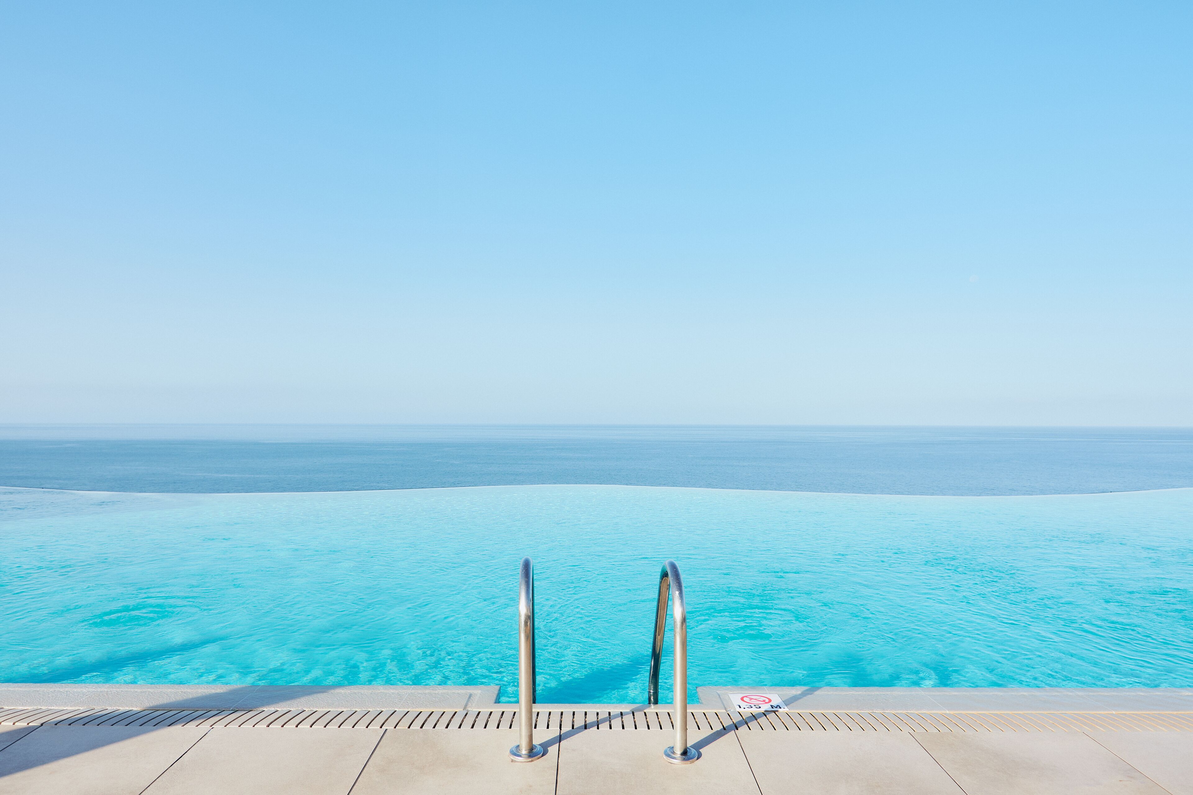 A infinity pool with a clear view of the ocean.