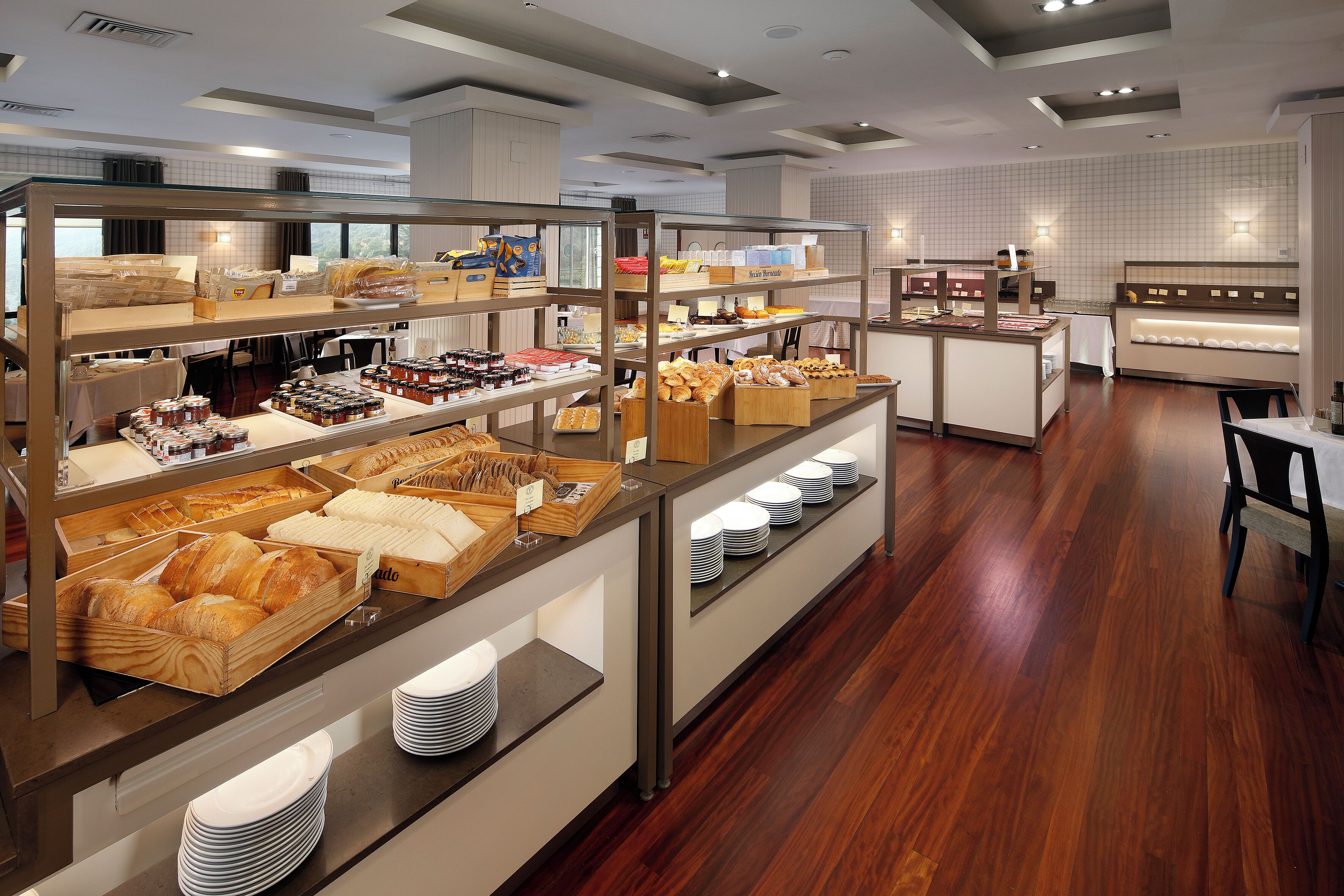 A breakfast buffet with various food items and a seating area.