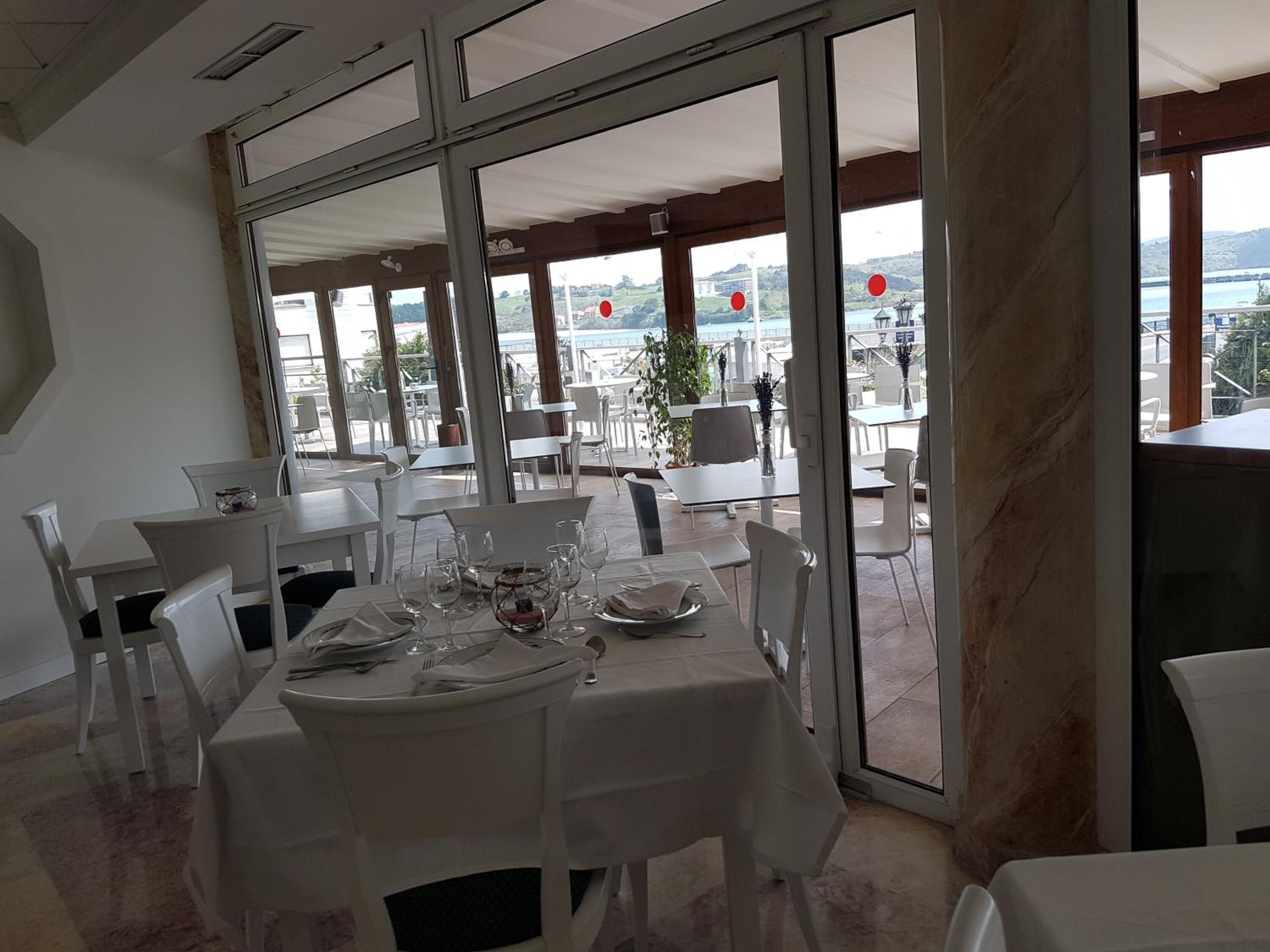 A restaurant with a terrace overlooking a scenic view.