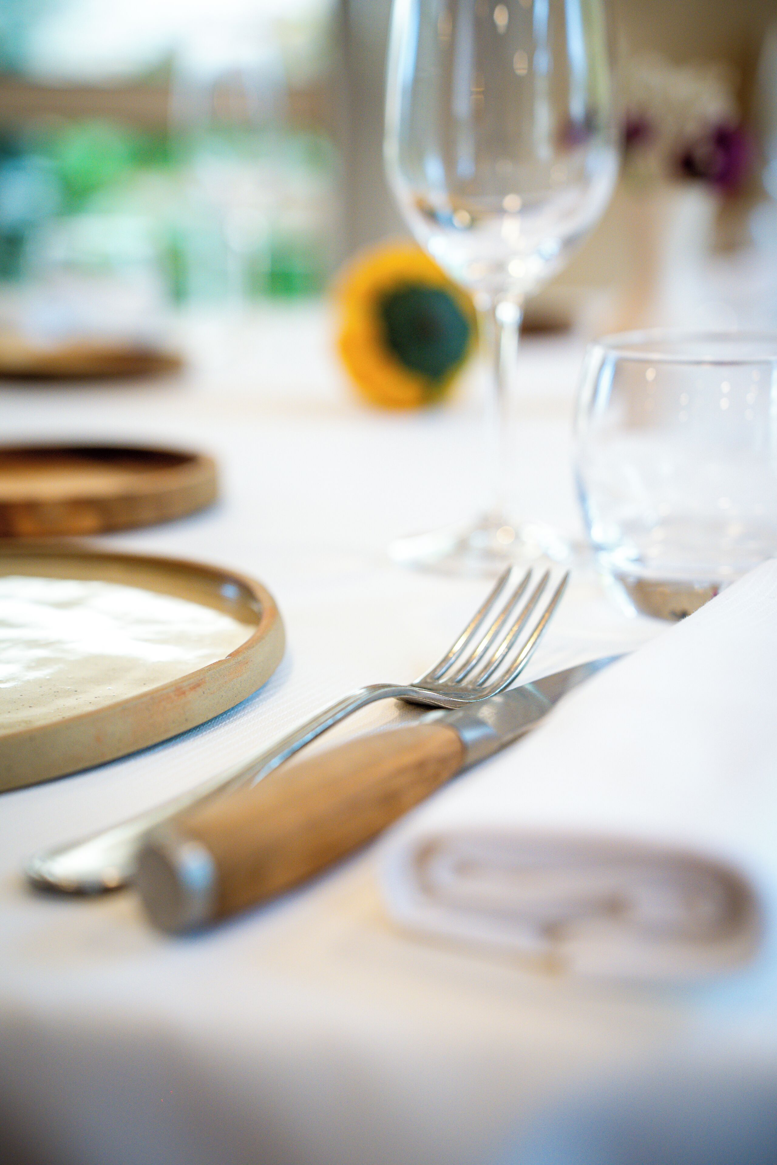 A table set with a plate, fork, knife, and glass.