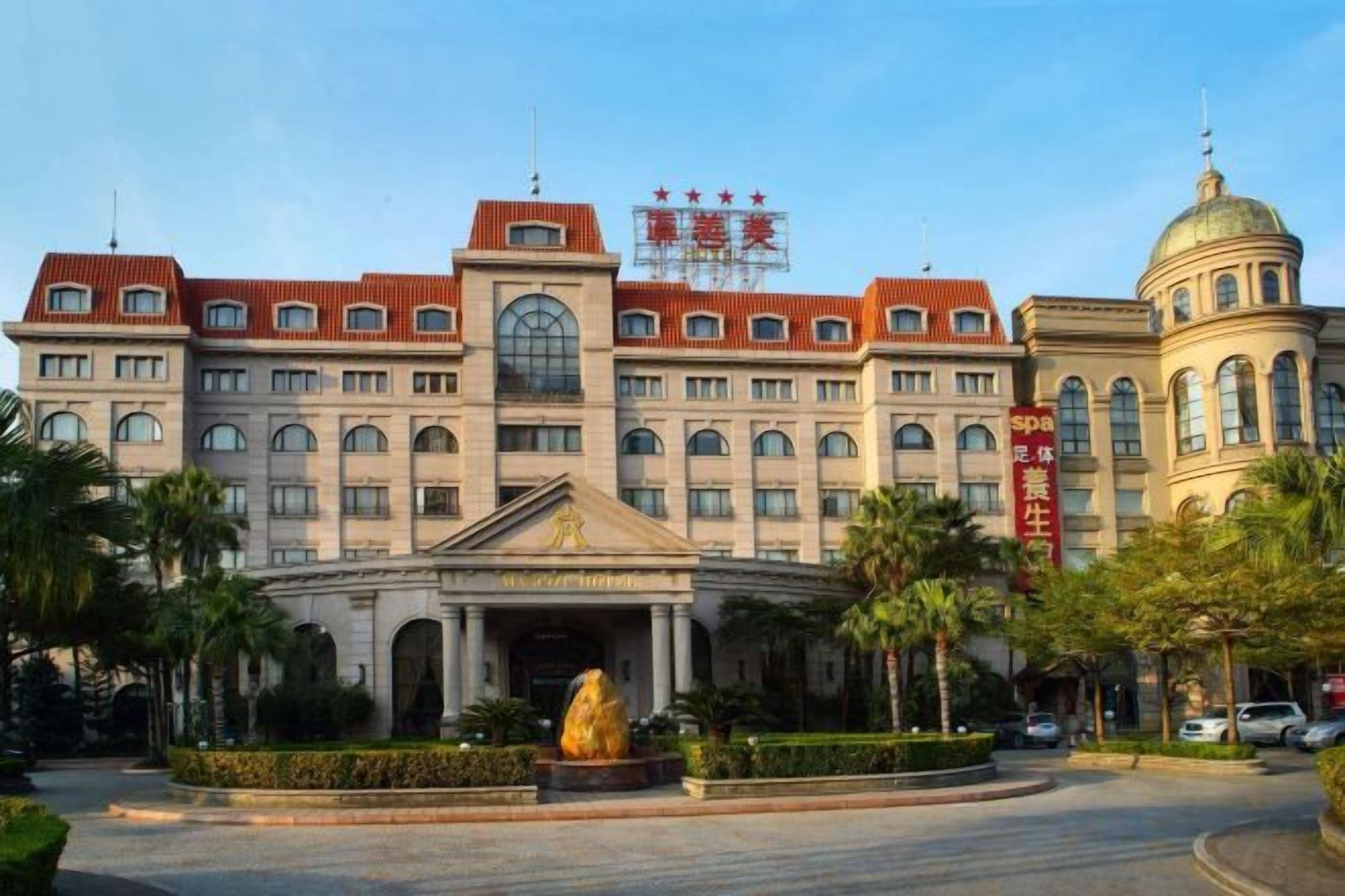A large, historic building with a central entrance, multiple windows, and a dome structure.