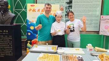 A table with various food items and a signboard in the background.