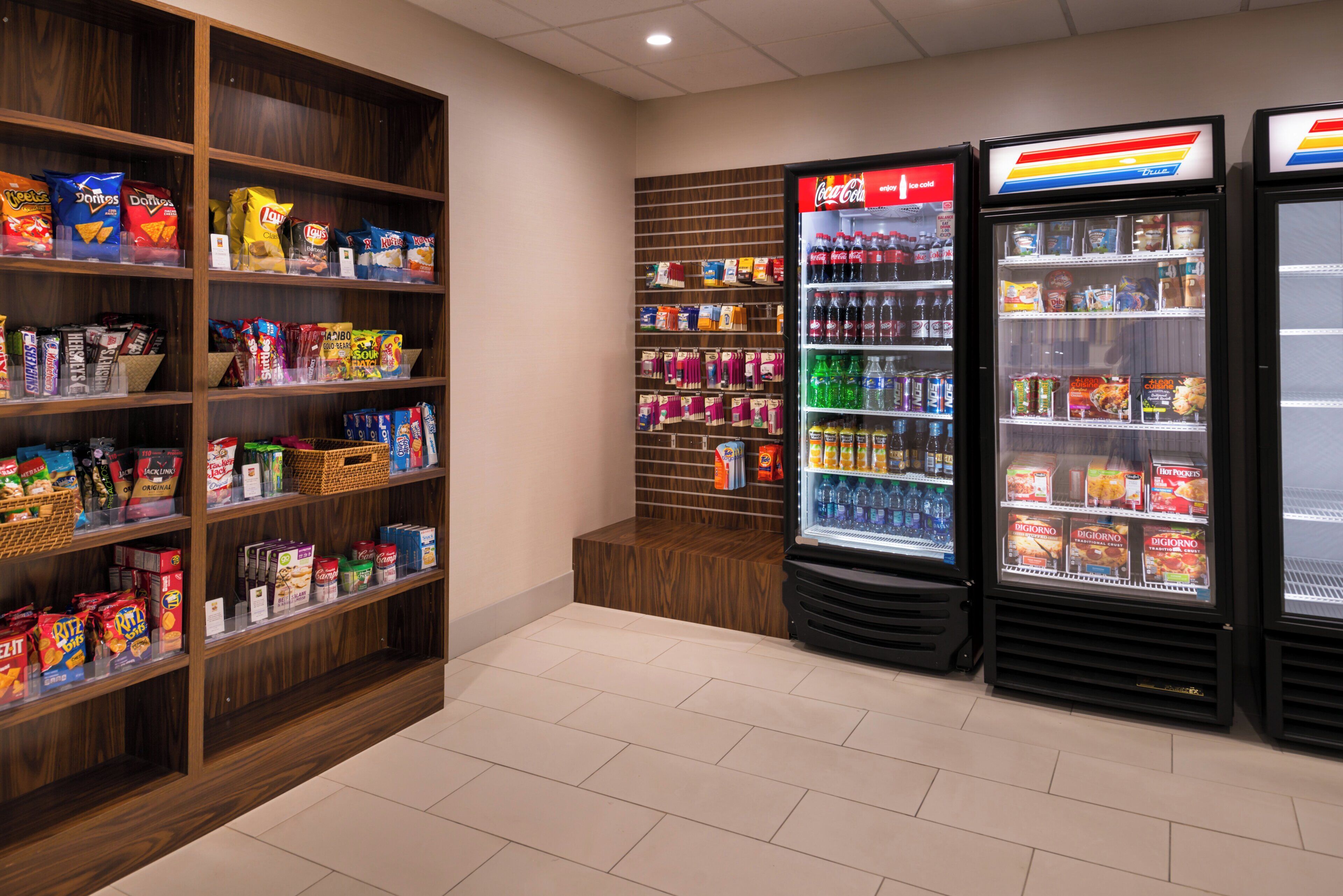 A snack and beverage vending area with various snack options and refrigerated drinks.