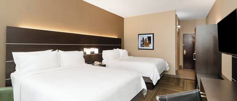 A hotel room with two beds, a desk, a chair, a television, and a picture on the wall.