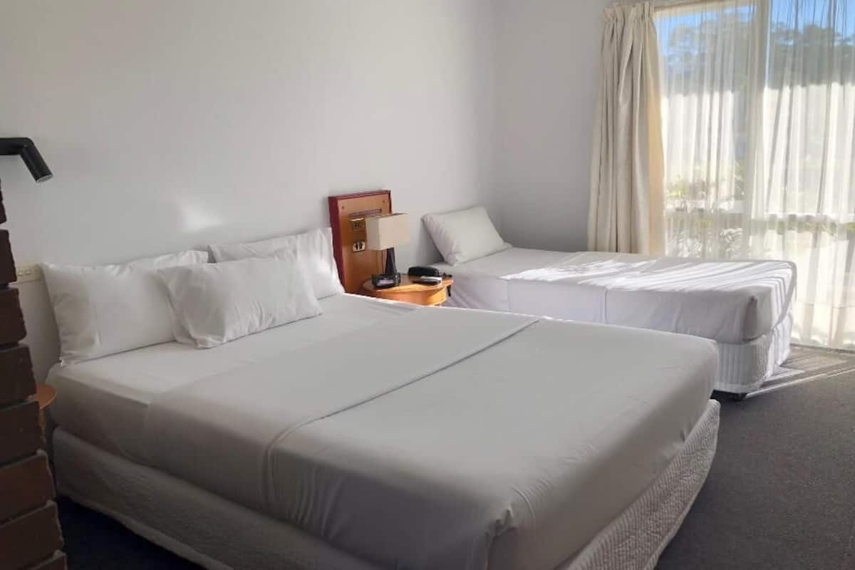 Premium bedding, pillow-top beds, laptop workspace, blackout curtains