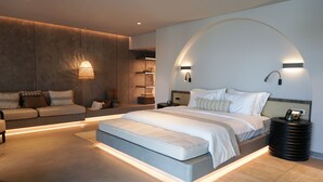 A modern bedroom with a large bed, built-in shelving, and ambient lighting.